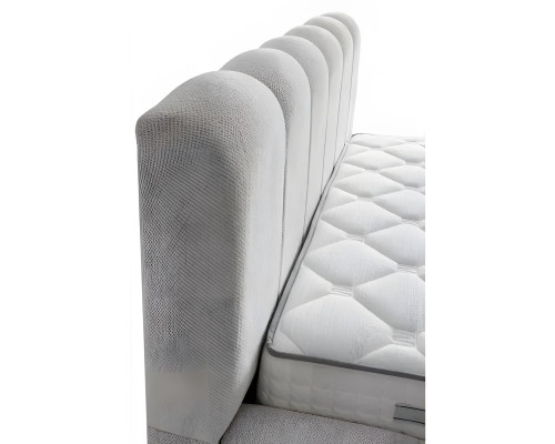 Bed made of modern white textile with quality mattress