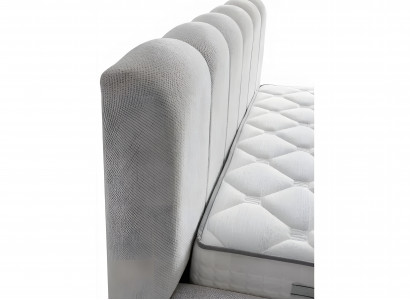 Bed made of modern white textile with quality mattress