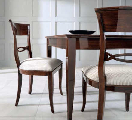 Elegant dining table with chairs in dark brown color with a glossy finish