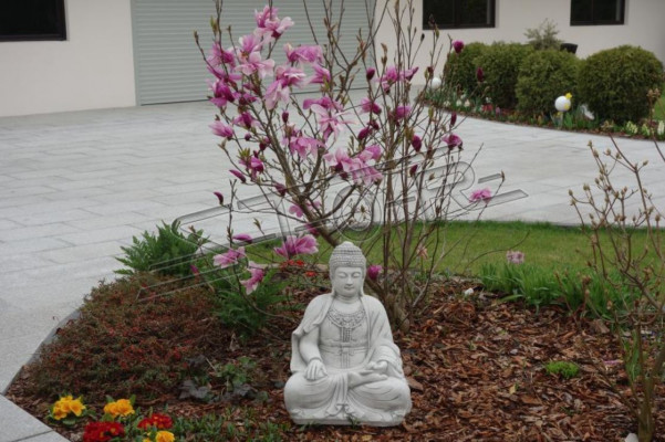 Buddha sculpture in stone look. Large statue figure for garden decoration.