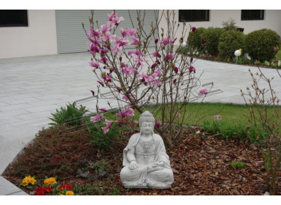Buddha sculpture in stone look. Large statue figure for garden decoration.