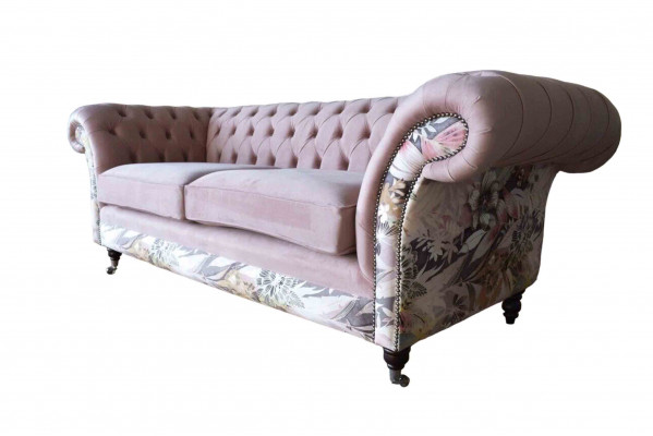 A lively three-seater Chesterfield sofa with a delicate pink floral pattern