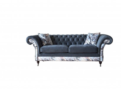 A striking three-seater sofa in Chesterfield design with delicate gray floral decoration.
