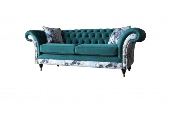 A lively three-seater Chesterfield sofa in a delicate emerald color with a floral pattern.