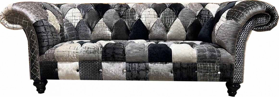 Luxurious velvet sofa in Chesterfield design with colorful checks