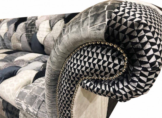 Luxurious velvet sofa in Chesterfield design with colorful checks