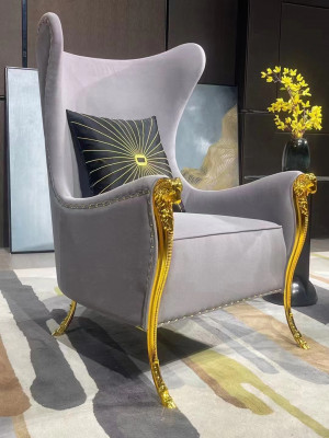 Luxurious armchair with decorative elements and gilded legs