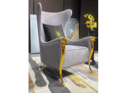 Luxurious armchair with decorative elements and gilded legs