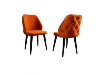Padded orange Chesterfield wooden chair on black legs the dining room