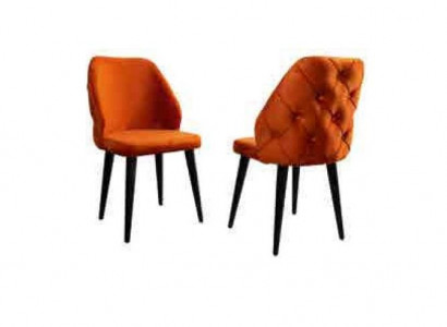 Padded orange Chesterfield wooden chair on black legs the dining room