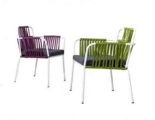 Original chair in light color on white legs with a soft seat cushion made of stainless steel.
