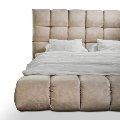 Luxury plush bed in the bedroom, large, handy designer bed, new interior.