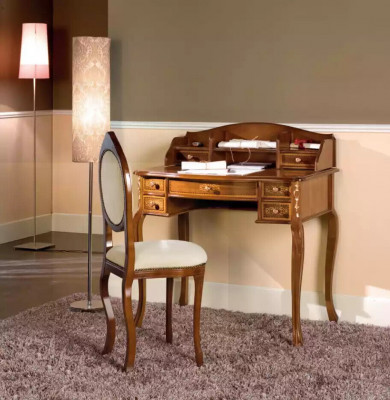Classic desk with a brown wooden chair in a study.