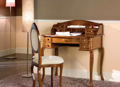 Classic desk with a brown wooden chair in a study.