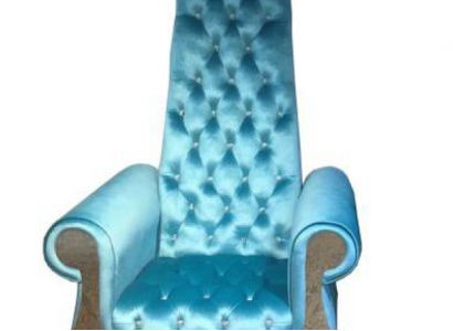 A refined armchair with a high backrest and a design reminiscent of a Voltaire chair.