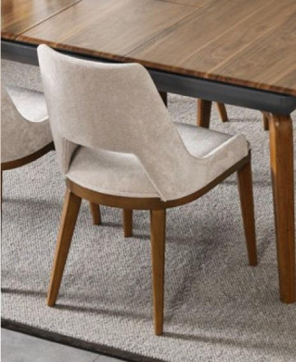 A laconic, modern chair with high wooden legs and upholstery in a pleasant, light cream color for the dining room.