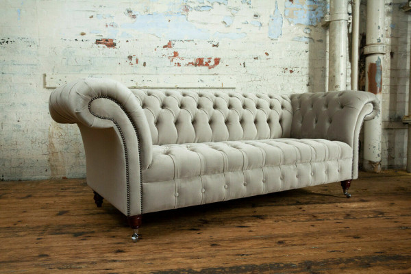 Stylish light gray Chesterfield three-seater luxury living room sofa