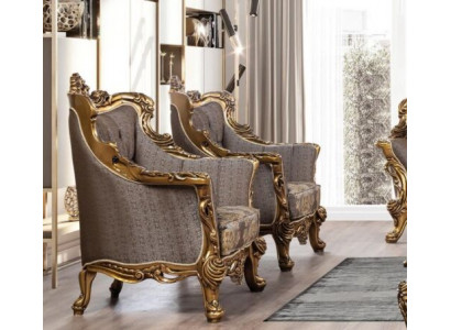 A luxurious classic wingback chair in dark gray with golden baroque design by Chesterfield