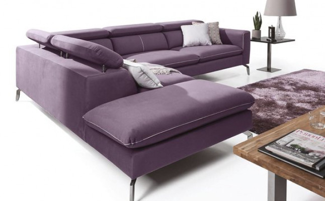A functional, stylish corner sofa in a modern style for your home in purple luxury upholstery.
