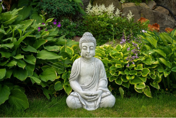 Buddha statue figure in stone look. Large sculpture for decorative garden.