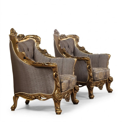 A luxurious classic wingback chair in dark gray with golden baroque design by Chesterfield