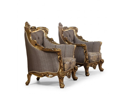 A luxurious classic wingback chair in dark gray with golden baroque design by Chesterfield