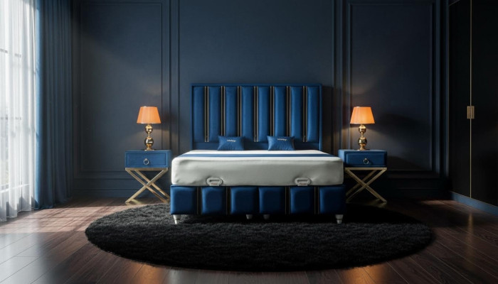 Sapphire blue designer bed with nightstands on gilded steel legs.