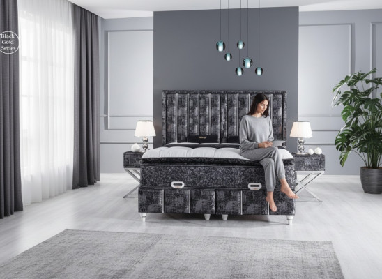 Black bed with mattress and two nightstands in the bedroom furniture set