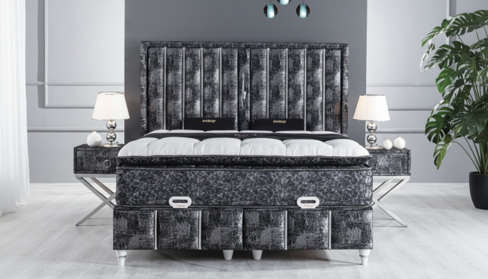 Black bed with mattress and two nightstands in the bedroom furniture set