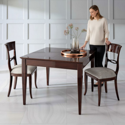 Elegant dining table with chairs in dark brown color with a glossy finish