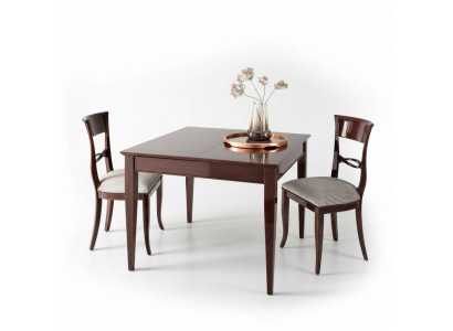 Elegant dining table with chairs in dark brown color with a glossy finish