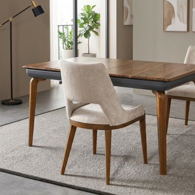 A laconic, modern chair with high wooden legs and upholstery in a pleasant, light cream color for the dining room.