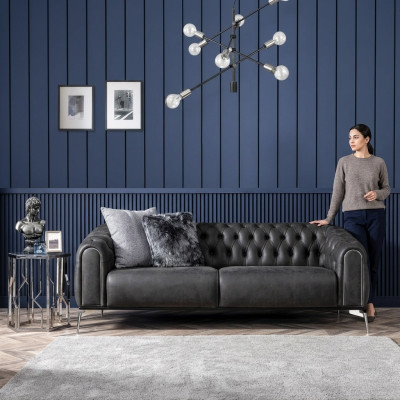 Black straight four-seater sofa in Chesterfield style for the living room.
