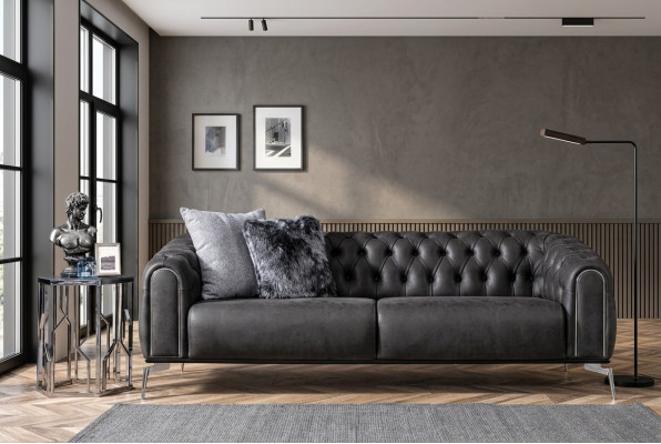 Black straight four-seater sofa in Chesterfield style for the living room.