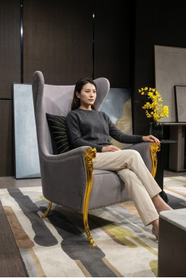 Luxurious armchair with decorative elements and gilded legs