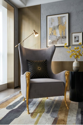 Luxurious armchair with decorative elements and gilded legs