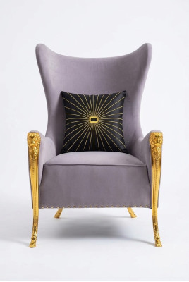 Luxurious armchair with decorative elements and gilded legs