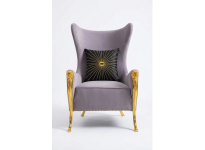 Luxurious armchair with decorative elements and gilded legs