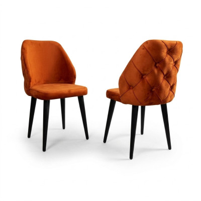 Padded orange Chesterfield wooden chair on black legs the dining room