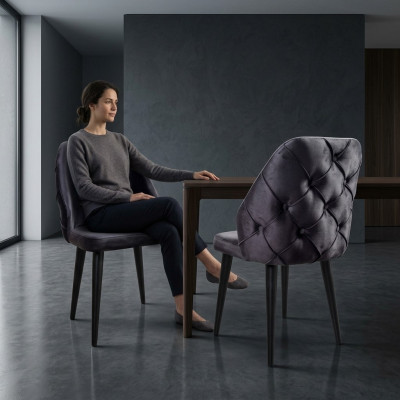 Padded gray wood chair, Chesterfield style, on black legs for dining room.