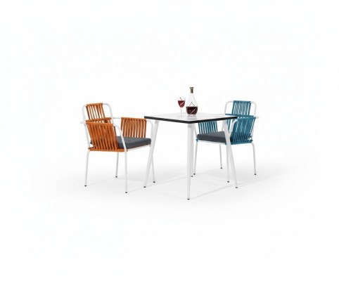 Original chair in light color on white legs with a soft seat cushion made of stainless steel.