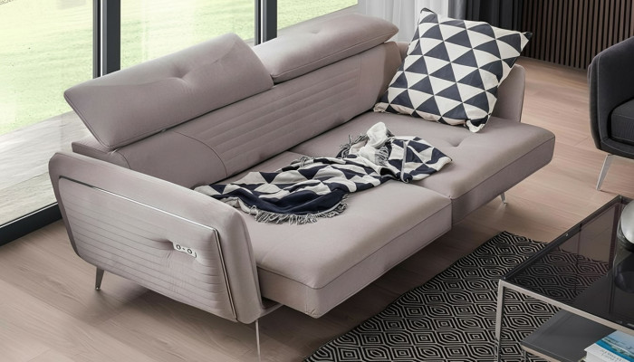 Luxurious, fashionable two-seater sofa with fabric upholstery on high legs