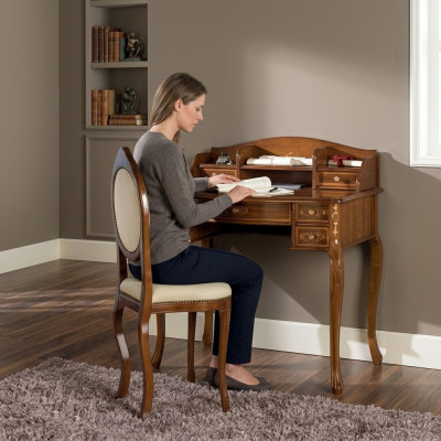 Classic desk with a brown wooden chair in a study.