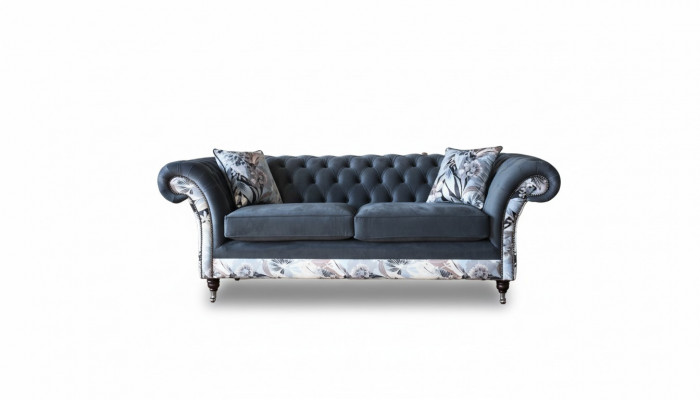 A striking three-seater sofa in Chesterfield design with delicate gray floral decoration.