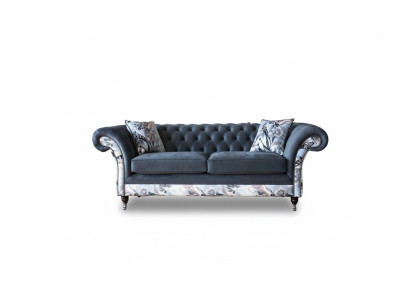 A striking three-seater sofa in Chesterfield design with delicate gray floral decoration.