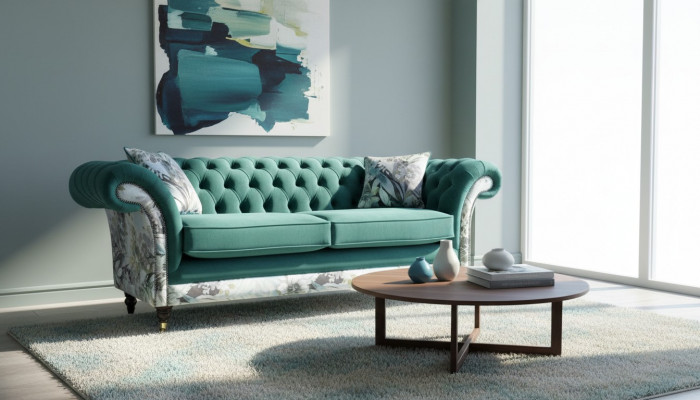 A lively three-seater Chesterfield sofa in a delicate emerald color with a floral pattern.