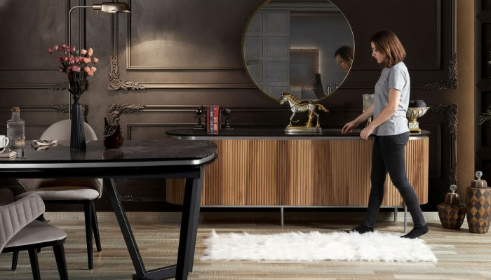 Luxurious dining room set consists of a modern black sideboard and mirror.