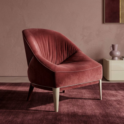 Red designer armchair with wooden legs, upholstered single-seater for living room furniture.