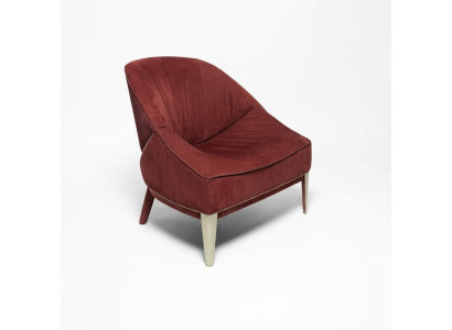 Red designer armchair with wooden legs, upholstered single-seater for living room furniture.