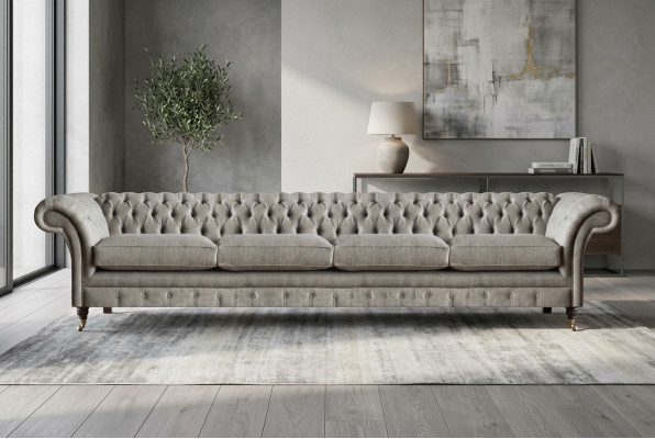Light gray Chesterfield upholstered sofa, designer 4-seater textile seating furniture.